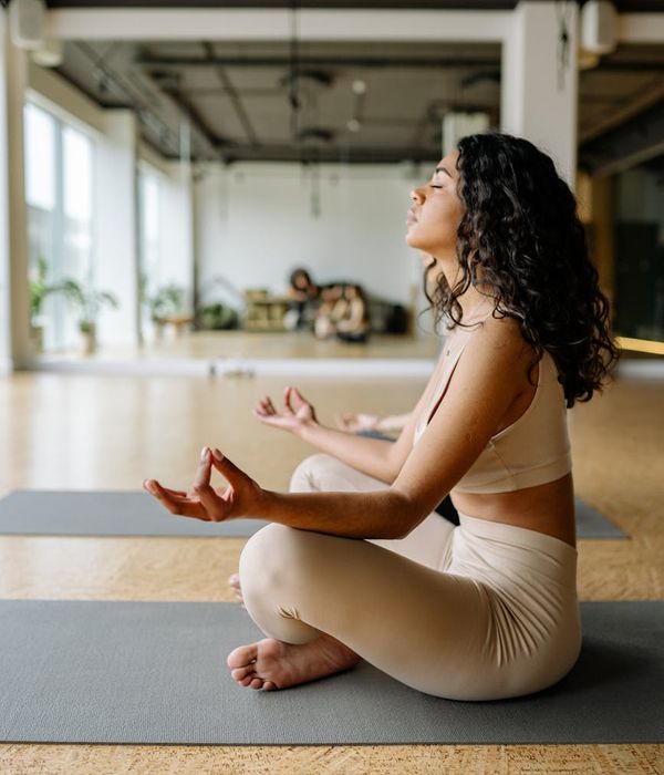 Person sitting calmly in a meditative state after a workout.
